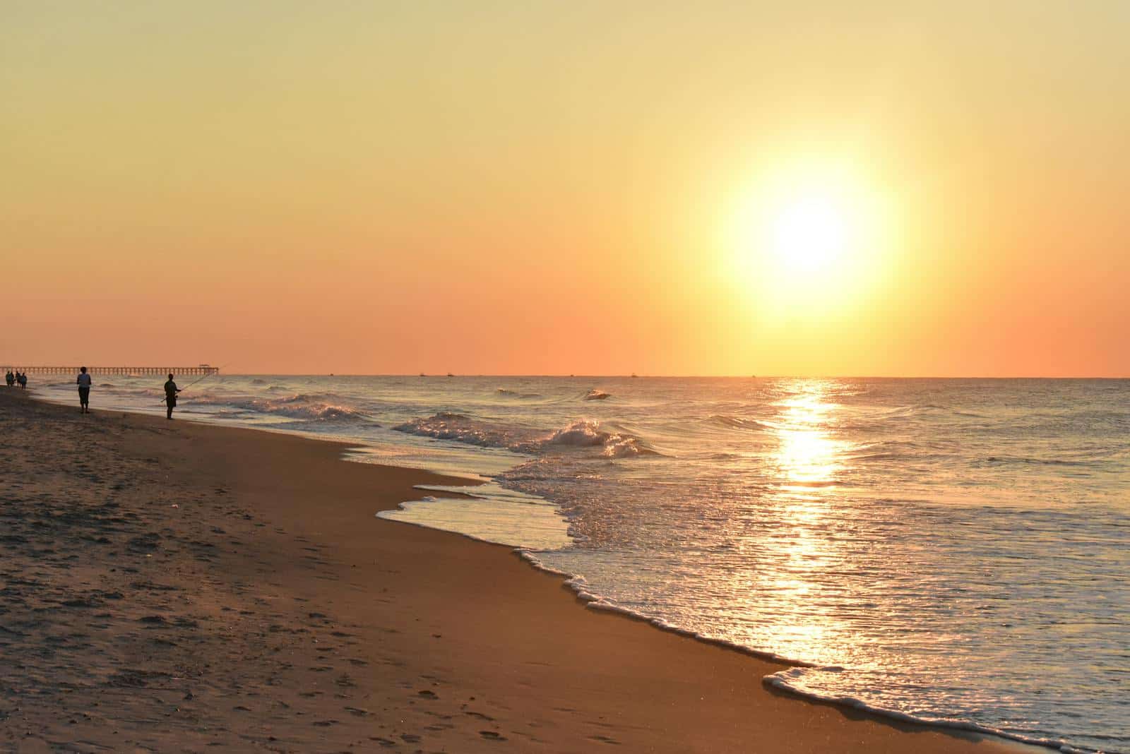 Serene sunrise at Myrtle Beach, with waves gently lapping the sandy shore. myrtle beach state park