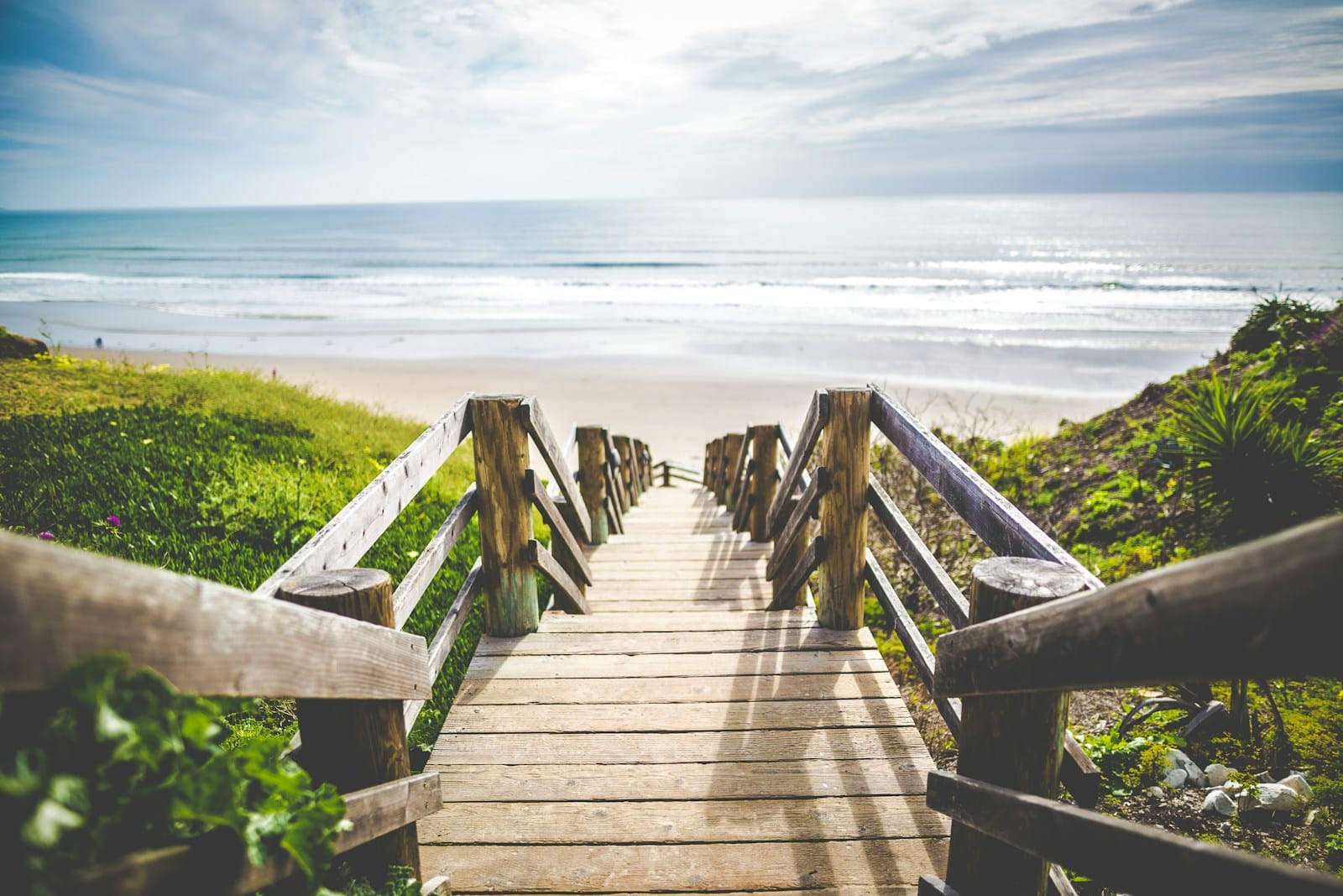 brown wooden walkway near beach during daytime best time to visit myrtle beach