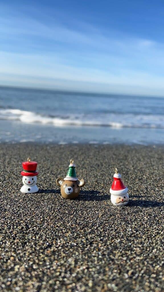 Festive Christmas ornaments on a sunny beach in Ureki, Georgia.