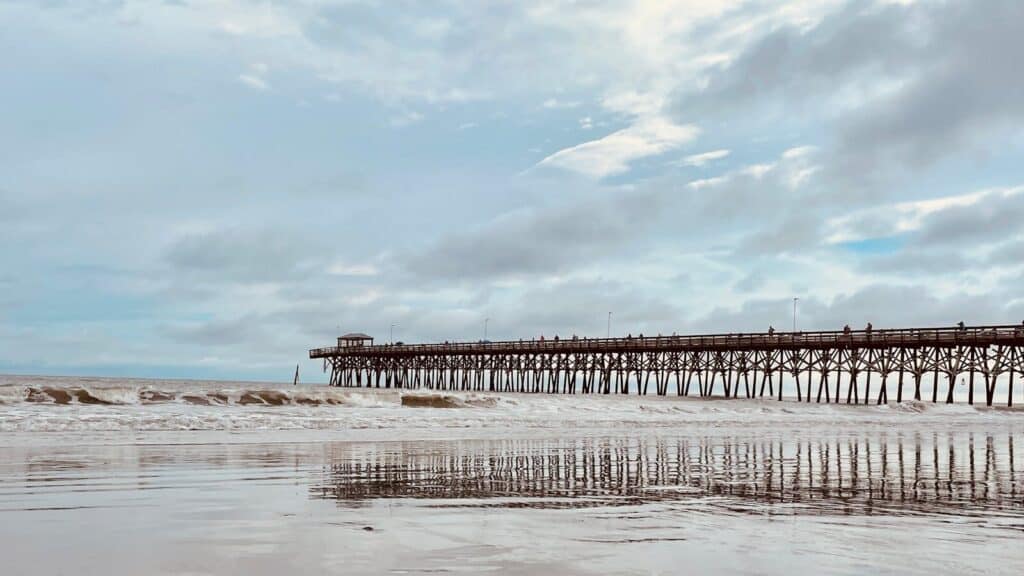 Peaceful Myrtle Beach scene with wooden pier at the seashore.