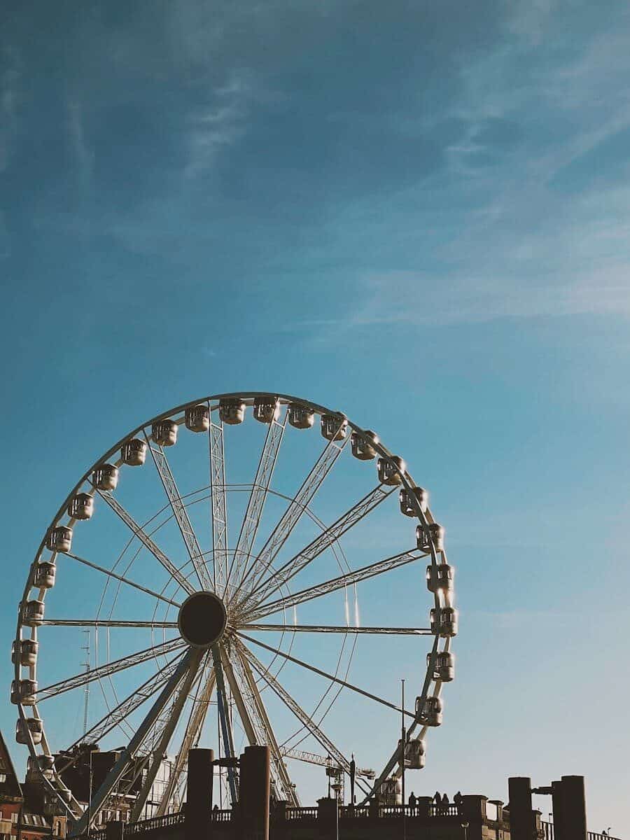 Ferris wheel in Antwerp with a clear blue sky, showcasing leisure and tourism appeal. Experience the Thrill of SkyWheel Myrtle Beach: Top Tips for Visitors