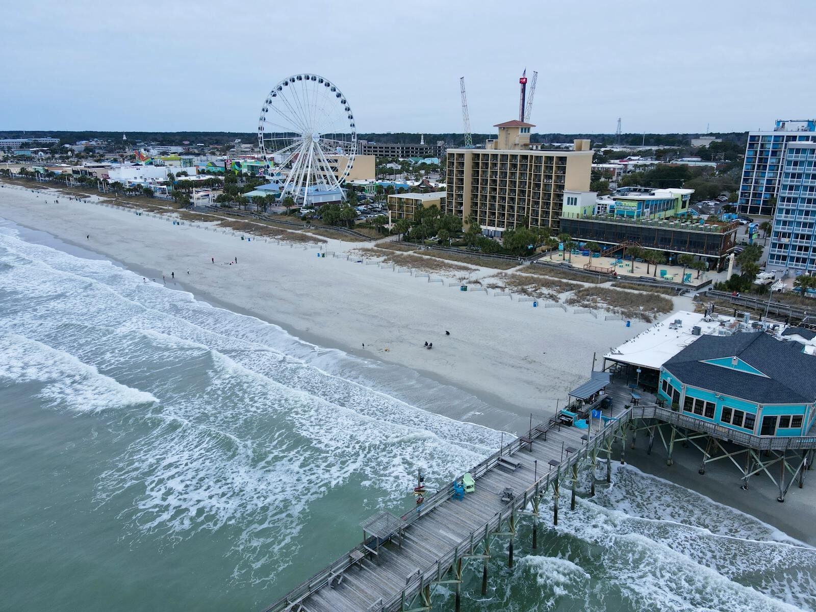 Aerial shot of Myrtle Beach with iconic pier and ferris wheel, capturing coastal beauty. Discover Carolina Pines RV Resort | A Hidden Gem for Your Next Adventure