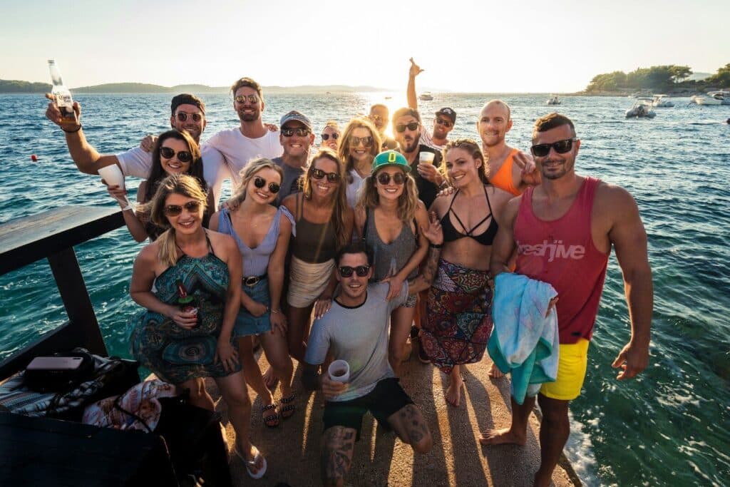 group of people standing on beach during daytime