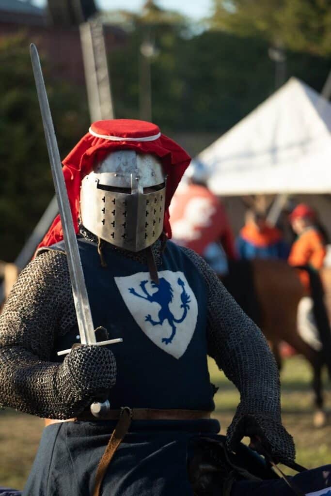 A man in a knight costume holding a sword