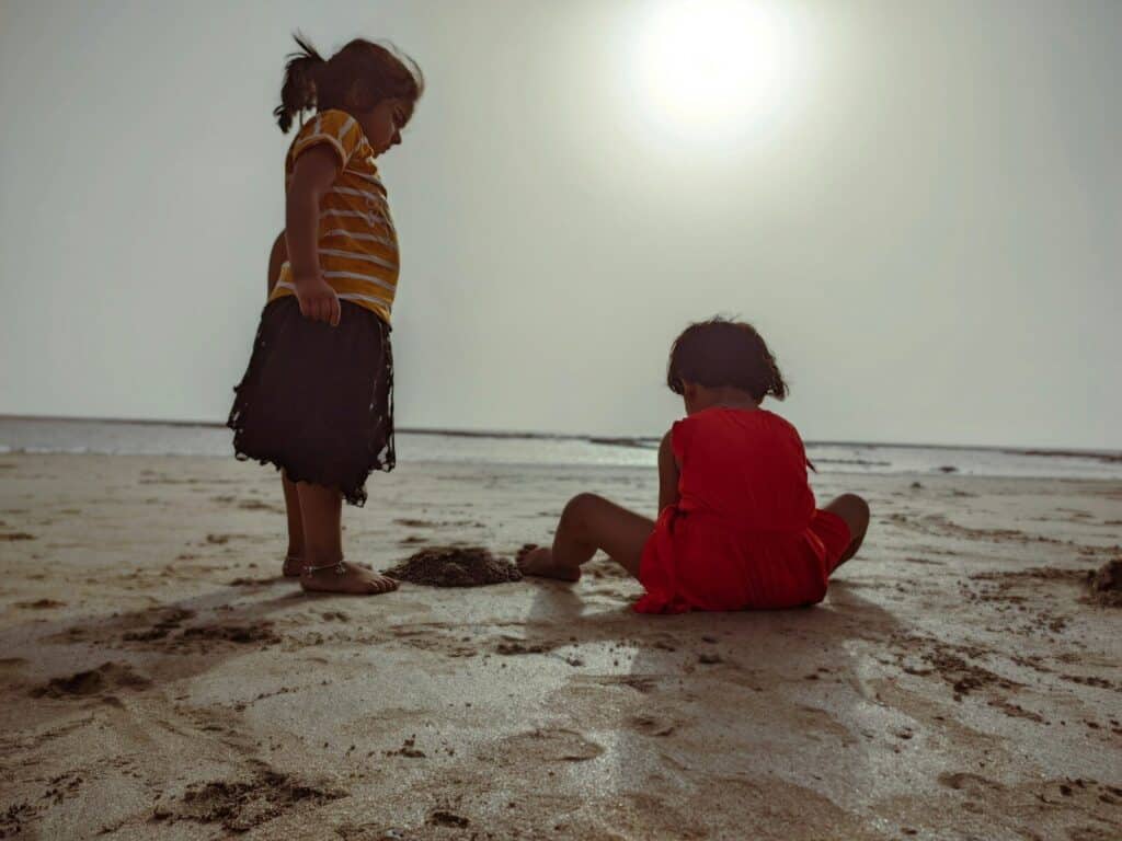 a man and a child playing on the beach