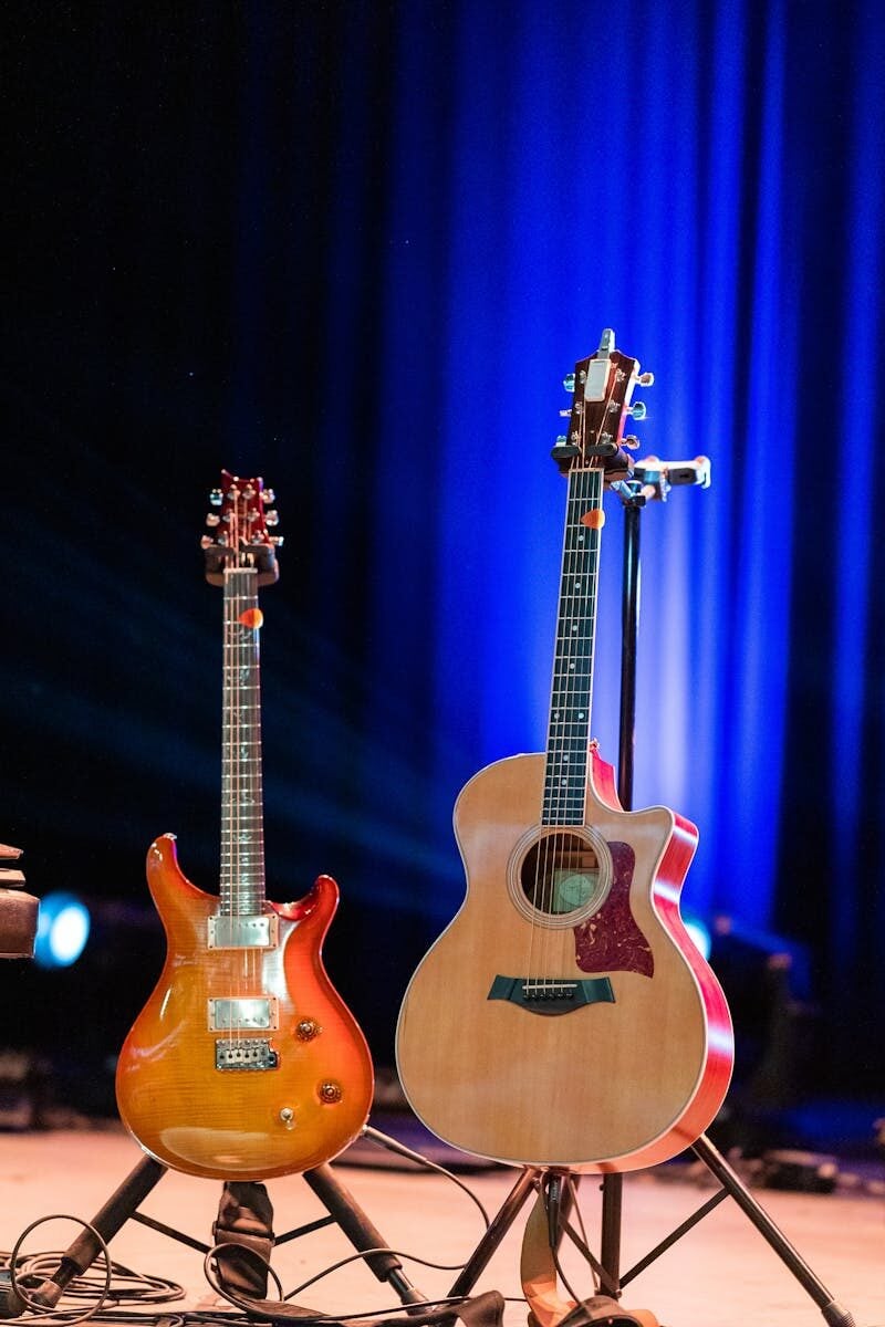 A captivating image of electric and acoustic guitars on a lit stage ready for a live performance.
