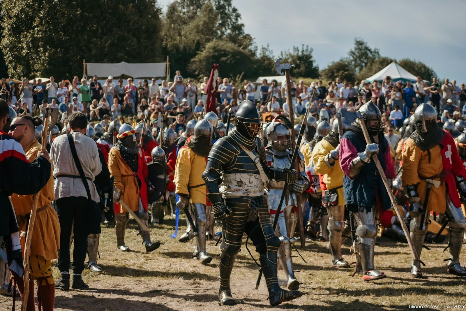 People in historical armor at a reenactment event