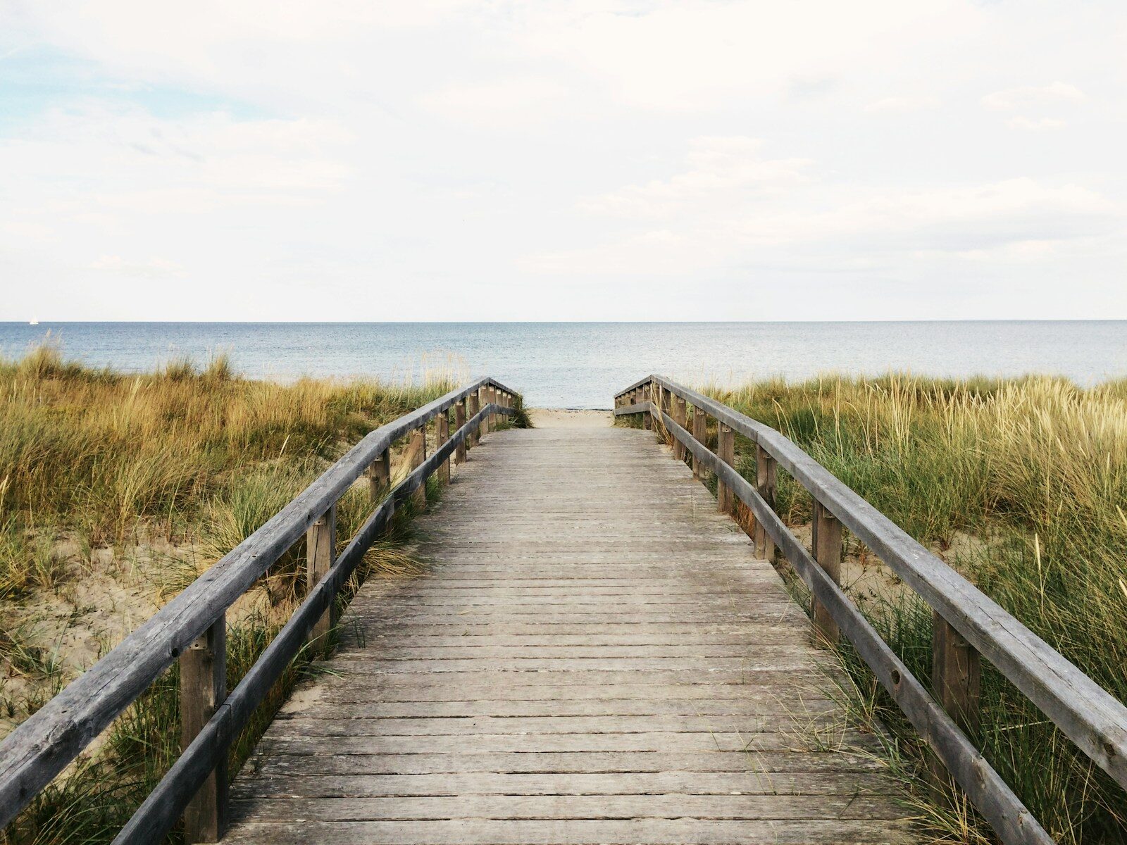 photo of gray wooden bridge